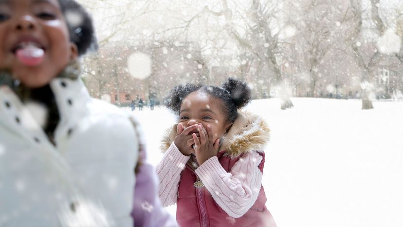 girls playing in the snow