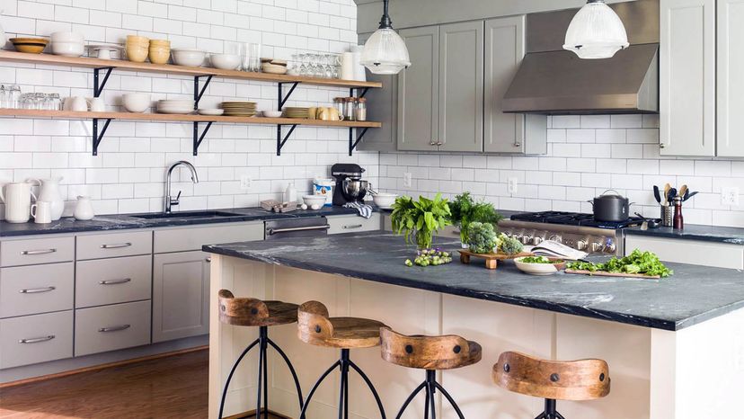 Vintage wooden cutting board on top of black stone kitchen stone