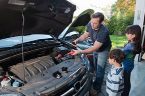 Family fixing car battery. 