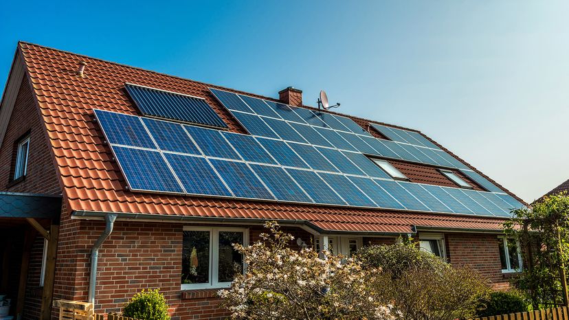 Solar panels cover the roof of a house.