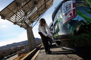 Heather Lammers plugs in a Toyota Prius Hybrid, which was being recharged by a solar energy panel at the National Renewable Energy Laboratory (NREL) in Golden, Colo.
