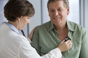 Doctor listening to patient's heartbeat with a stethoscope