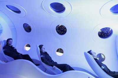 Virgin employees sit in the cabin of a prototype Virgin Galactic SpaceShipTwo spacecraft, destined to be the first ever vehicle for space tourism.