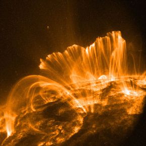 Coronal loops extend from the surface of the sun along complicated magnetic lines.