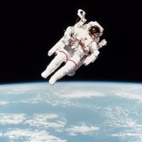 Astronaut Bruce McCandless II using a manned maneuvering unit (MMU) outside of the Space Shuttle Challenger. This was the first untethered spacewalk in history.