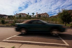 A car passes over a large speed bump on Coto de Caza Drive in Coto de Caza, Calif.