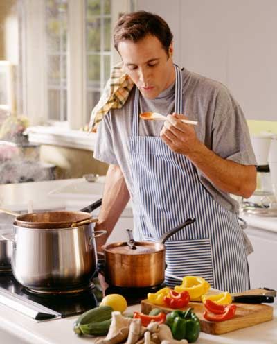 man cooking and tasting food