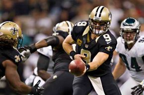 Drew Brees (No. 9) of the New Orleans Saints makes a hand-off against the Philadelphia Eagles in 2012.  Brees has said that the only questions he gets asked these days are about the bounty scandal.