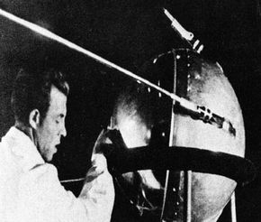 A Soviet technician makes adjustments to the Sputnik satellite.