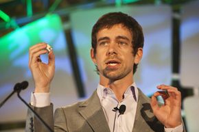 Jack Dorsey, creator of Twitter and founder of Square, holds up the Square device as he speaks during the TechCrunch Disrupt conference in New York in 2010.