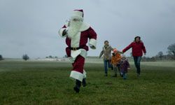 Chasing Santa through a field is a good way to increase your heart rate. See more Christmas pictures.