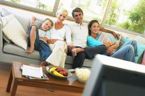 Family of four watching TV