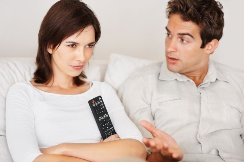 couple fighting  with tv remote