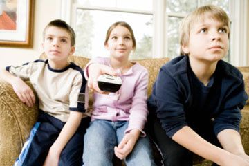 Children watching TV with remote control