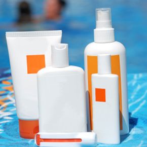 Different bottles of sun protection products at the pool.
