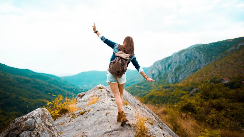 Young Hippie girl enjoying hiking on a mountain.