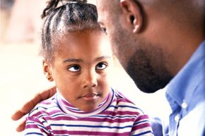 Father talking to young daughter