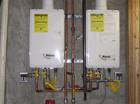 Two water heaters on a wall.