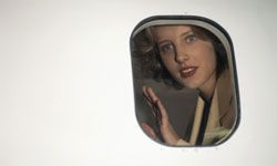 woman staring out of an airplane window