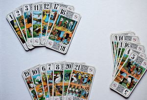 tarot cards spread out on white tabletop