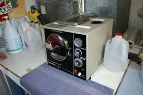 An autoclave sterilizes tattoo equipment before each use.