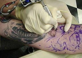The tattoo artist fills in a tattoo using a thicker needle. See the needle in action.