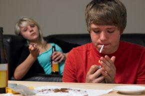 Teenage Couple Taking Drugs At Home