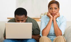 parent and teenager on computer