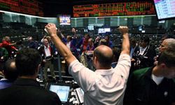 A trader at the Chicago Board of Trade watches as the Dow Jones Industrial Average, S&P 500 and NASDAQ Composite Index all fall upon news of soaring gas prices in July 2008.