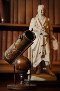 Telescopes have been around for ages, or rather, centuries. You're looking at one made by Isaac Newton. That's a statue of the great brain, too.