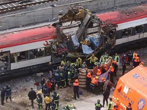 Rescue workers cover up bodies following a 2004 train bombing in Madrid, Spain, March 11, 2004. The terrorist attack killed more than 170 commuters and wounded more than 500.