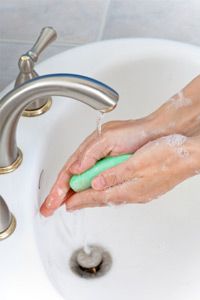 Washing hands with soap.