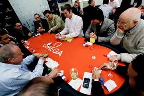 Men gambling around a table with leisure games and chips.