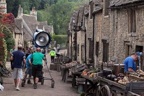 A film crew moves lights on the set of 'War Horse' which was filmed in Chippenham, England in 2010. It helps to have muscles on a film set. See more in our movie-making image gallery.