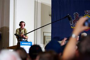 A boom operator records crowd sound as Republican presidential candidate Mitt Romney greets supporters in Pennsylvania in 2012. Strong shoulders are a must for this job.