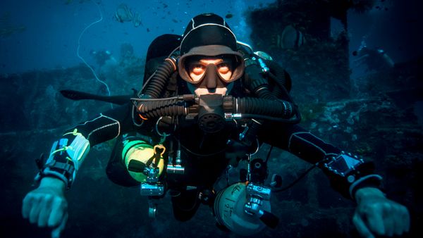 Men scuba diving for extreme underwater sports.