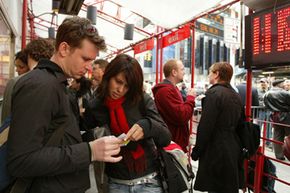 Mario Voegeli and Angela Harp of Zurich, Switzerland, check their tickets to "The Glass Menagerie," after purchasing them at the TKTS booth in Times Square in New York.