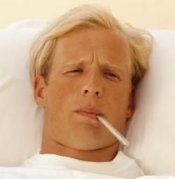 man with thermometer in bed