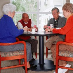 elderly people playing cards