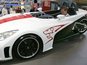 A man sits in the Peugeot 20 Cup, a three-wheeler concept vehicle by French automaker Peugeot, at the 61st IAA International Auto show in Frankfurt, Germany, on Sept. 13, 2005.