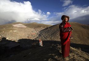 Tibet Image Gallery A Buddhist nun enjoys the fresh air outside the Serthar Wuming Buddhist Study Institute (elevation: 12,100 feet) in Tibet.