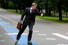 man in suit rollerblading