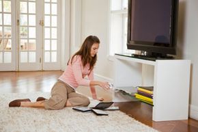Woman putting DVD in DVD player