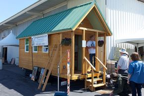 People visit a Tumbleweed Tiny House at the 2012 Maker Faire in San Mateo, California.