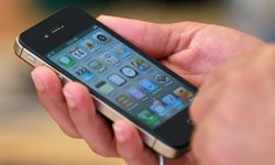 An Apple Store customer looks at the new Apple iPhone 4Gs on October 14, 2011 in San Francisco.