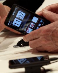 A visitor examines an HTC smartphone at the Vodafone stand at the CeBIT Technology Fair on March 3, 2010 in Hannover, Germany.