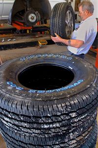 Tire specialist Vic Howlett installs tires on a vehicle at Lauterbach Tire and Auto Service in Springfield, Ill.