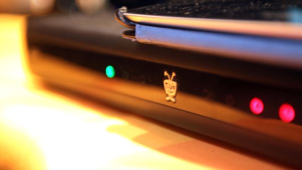 A black TiVo recording device on table