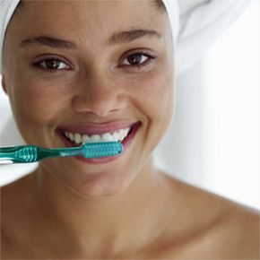 woman brushing her teeth