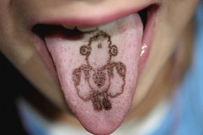 A child has a tongue tattoo. 
